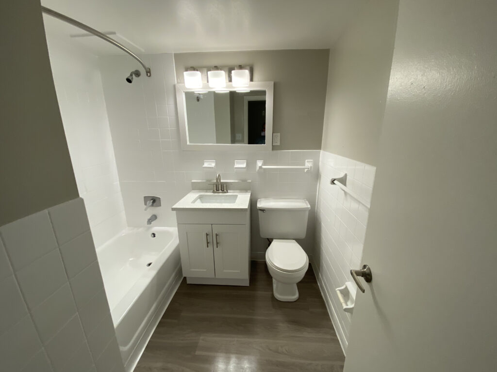 Countertop, Cabinet, Glazing, Light Fixture, mirror trim, flooring, toilet, Paint, Plumbing fixture, Tile